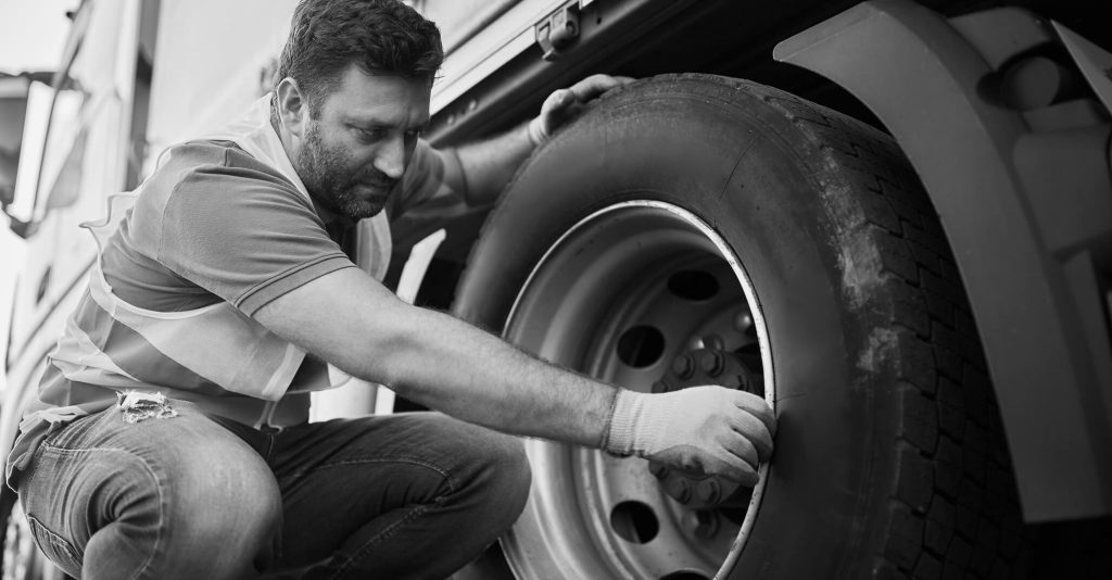 Man changing truck tyre